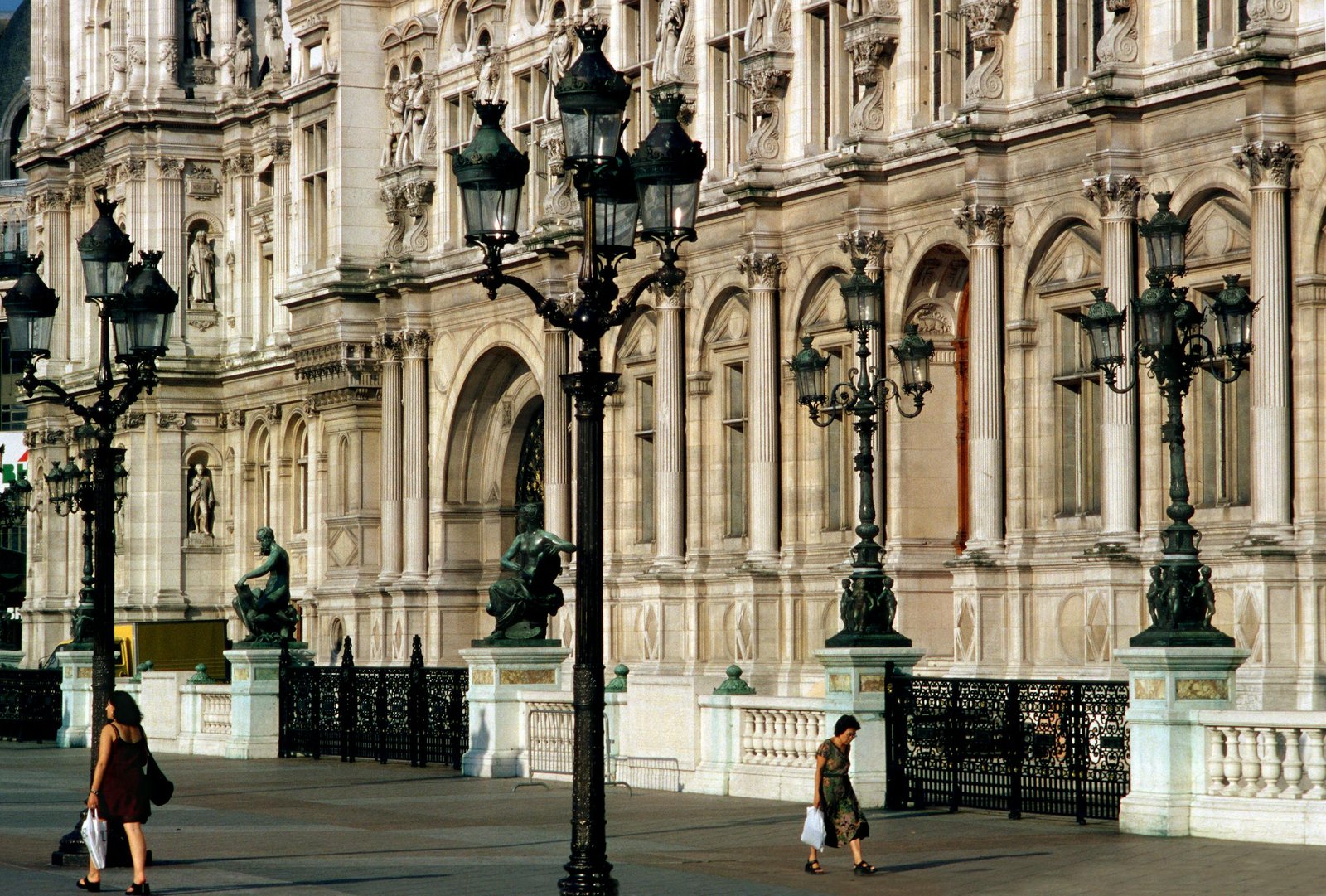 exterior view of hotel de ville paris with iconic street lamps and pedestrians. 7052280 scaled