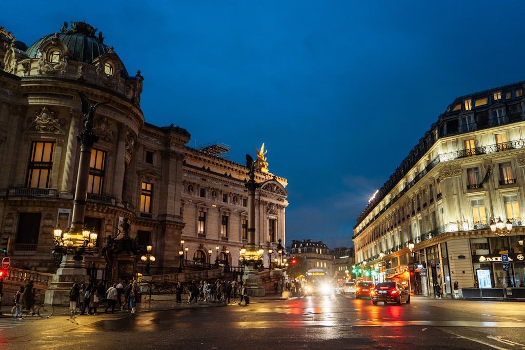 Paris night scene featuring the Opéra Garnier, vibrant city life, and illuminated streets.