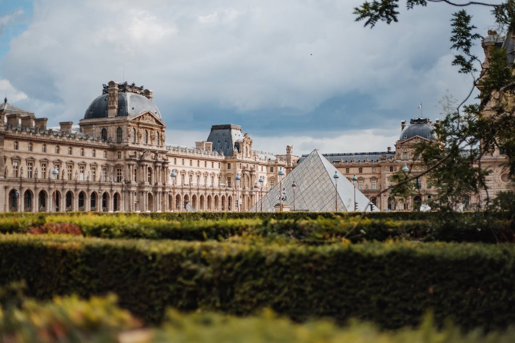 Scenic view of the Louvre Museum and Pyramid in Paris on a sunny day.
